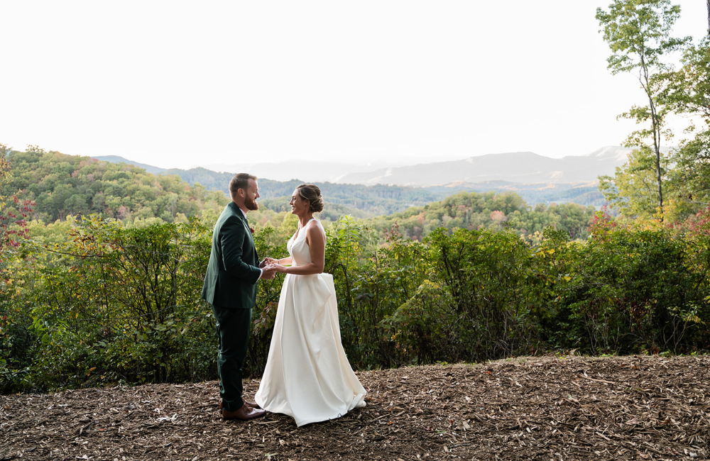 Bride and groom with view behind at Outland Great Smoky Mountains Chalet & Suites