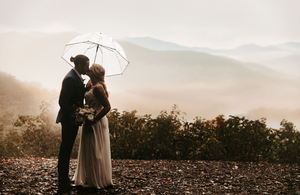 Couple with umbrella at Outland Great Smoky Mountains Chalet & Suites
