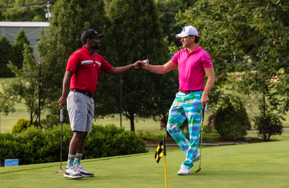 Golfers fistbump at Skyview Golf Tournament