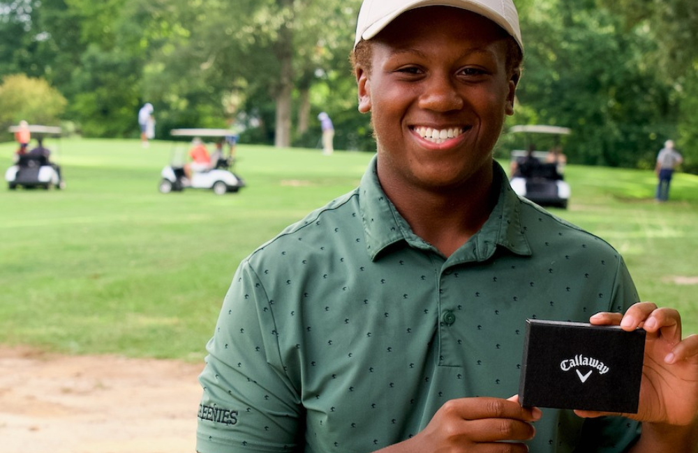 Man holding prize at Skyview Golf Tournament