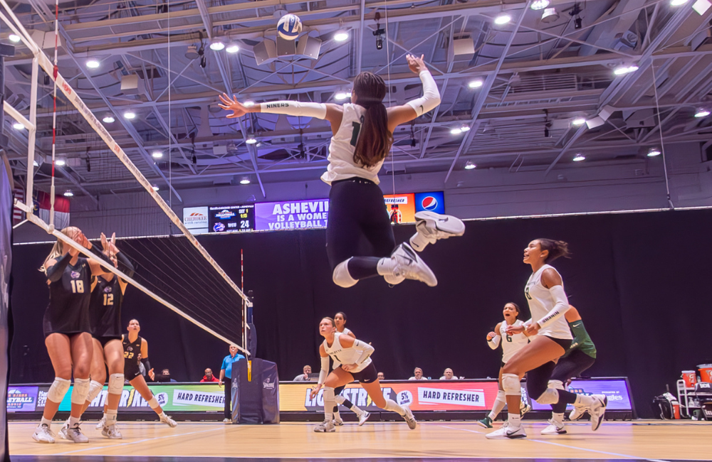 Photo by Steve Atkins of woman leaping for volleyball