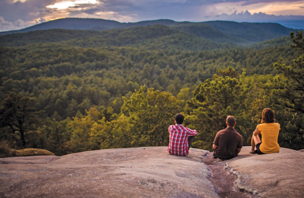 Brevard NC three hikers enjoying a vista from a rocky outcropping