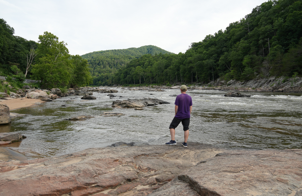 Man taking in the view of the French Broad River near Hot Springs, NC
