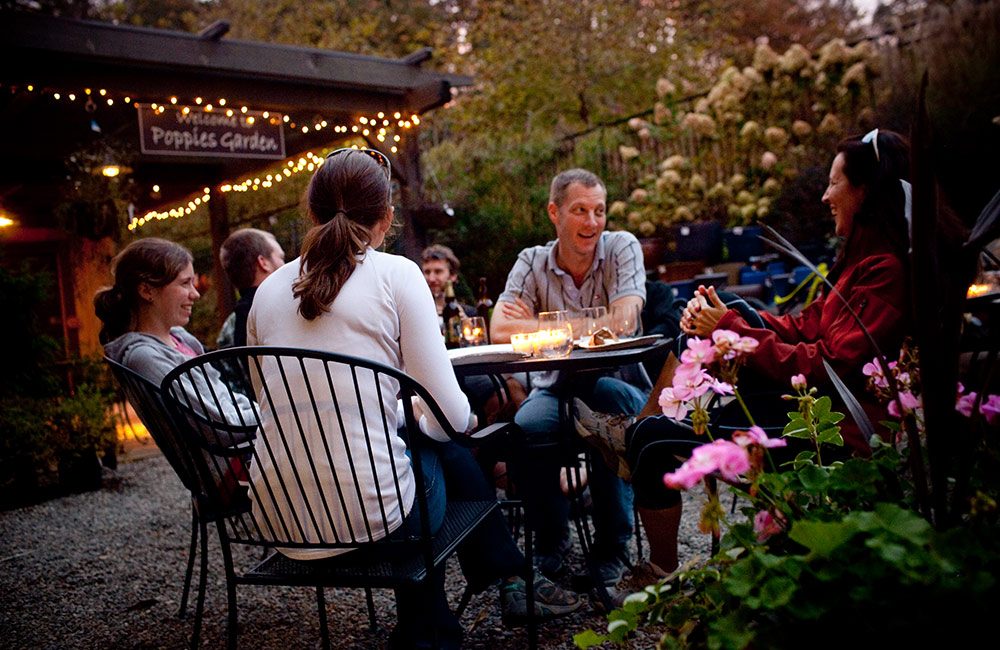 A family enjoying a meal outdoors in the evening