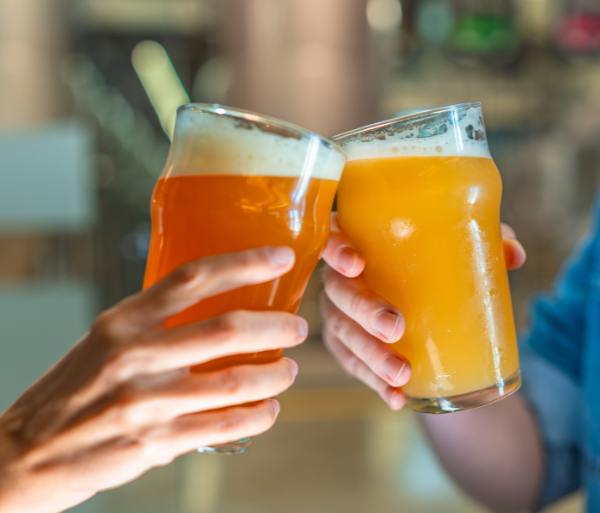 Two women toasting with pints of beer