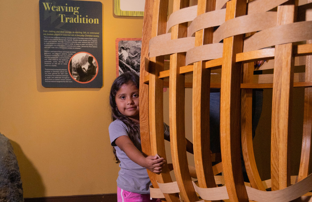 A child exploring the museum of the Cherokee people