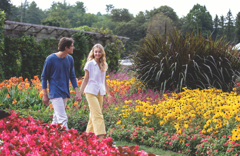 Couple strolling a garden in full bloom at Biltmore