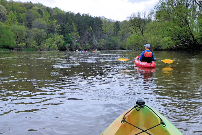 People kayaking on the French Broad River in Madison County NC