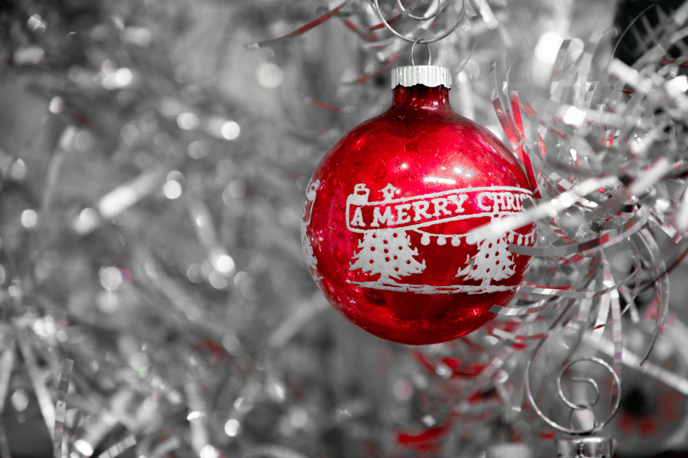 Red aluminum ornament on a silver aluminum christmas tree