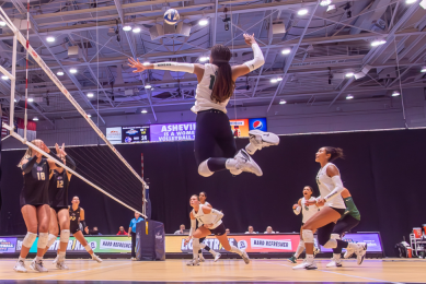 Photo by Steve Atkins of woman leaping for volleyball